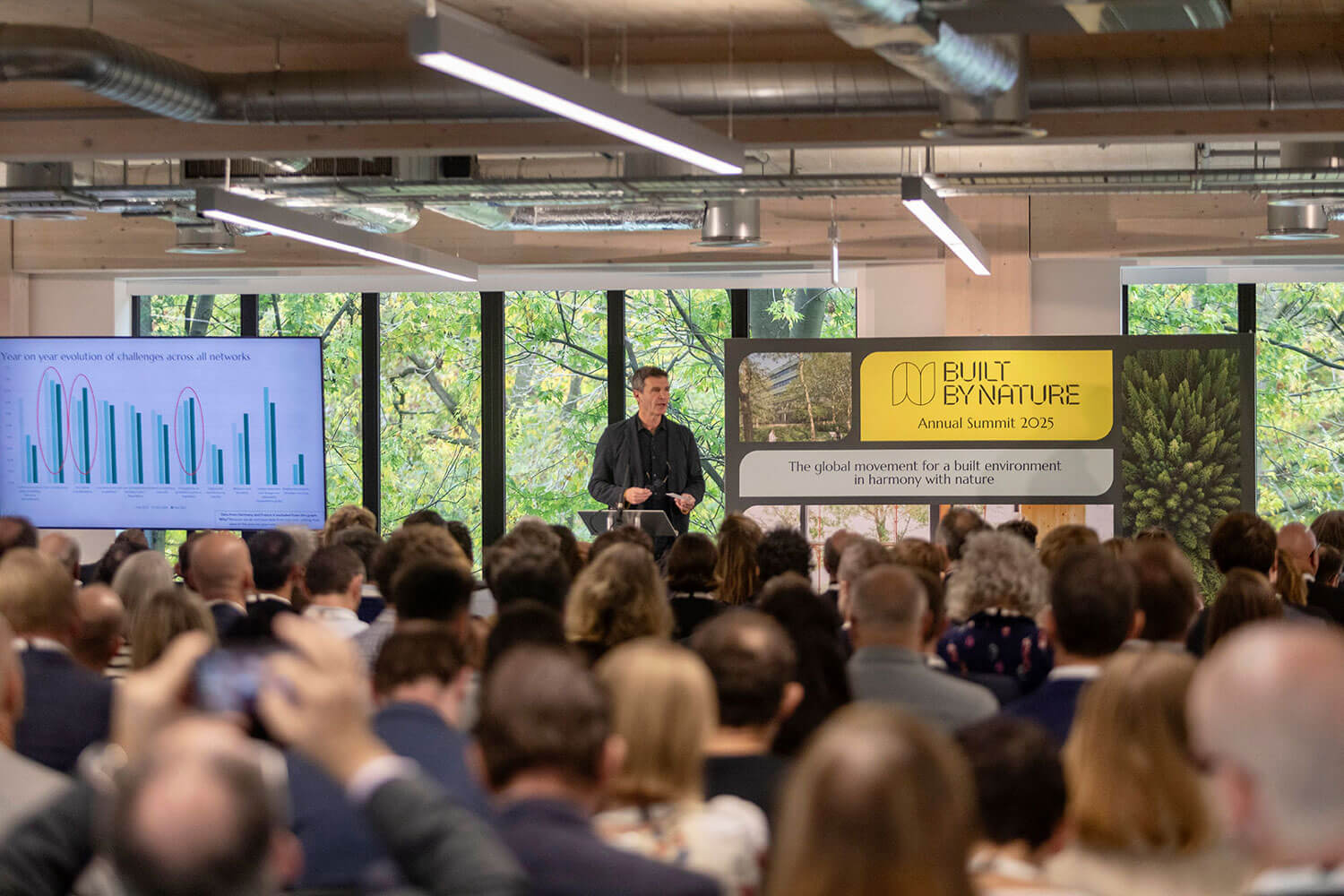 Paul King giving a presentation in front of an audience at an architecture summit