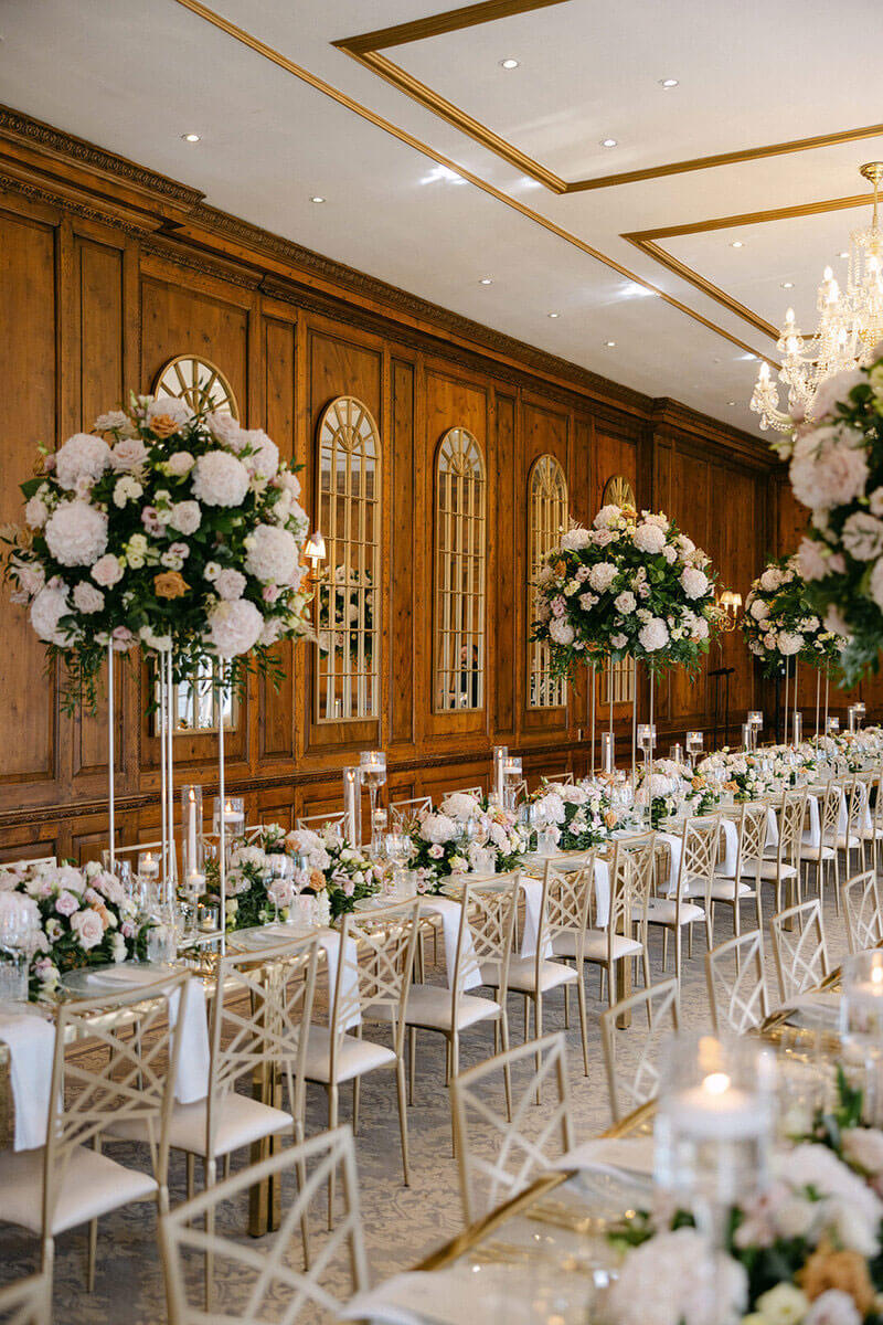 Elegant wedding catering setup with floral arrangements and candles in the grand Hedsor House